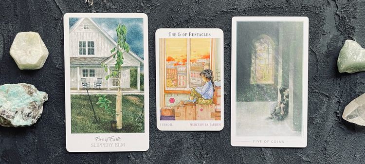 five of pentacles from the herbcrafter's tarot (left), the next world tarot (center), and the fountain tarot (right)