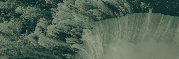 photograph of dam filled with rapidly moving water