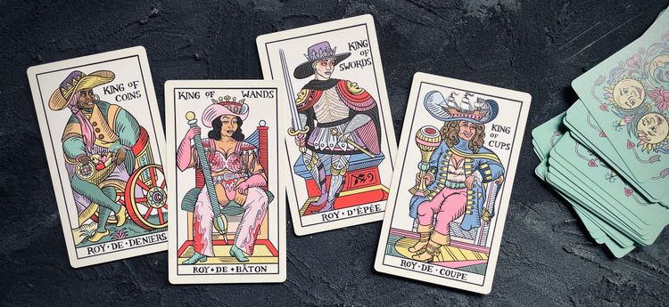 (left to right) king of coins, king of wands, king of swords, and king of cups from the gay marseille tarot