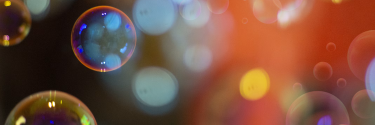 soap bubbles against a blurred out colorful background