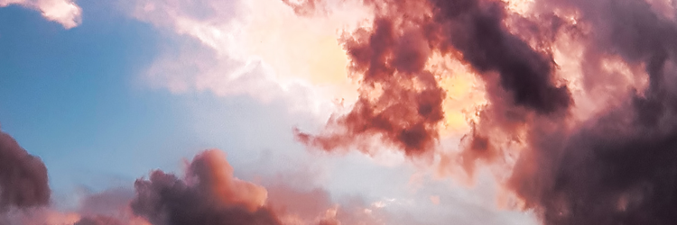 dark purple and red clouds in a blue sky