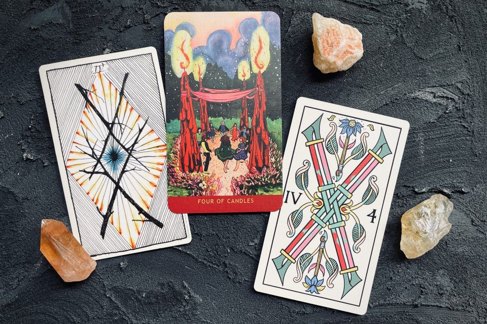 four of wands from the wild unknown tarot (left), the numinous tarot (center), and the gay marseilles (right)