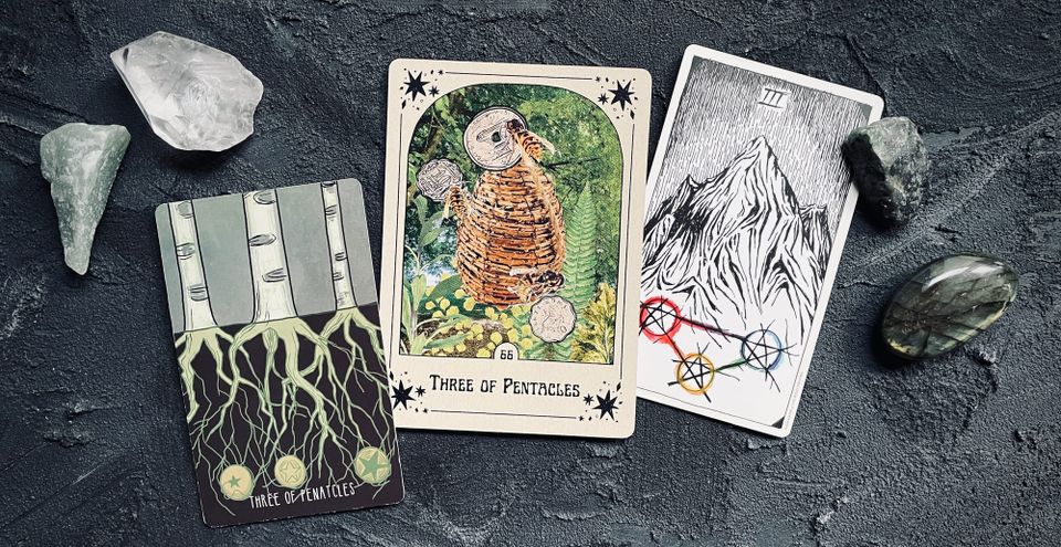 three of pentacles from three different tarot decks