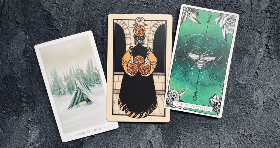 four of pentacles cards from the fountain tarot (left), fyodor pavlov tarot (center) and lumina tarot (right)