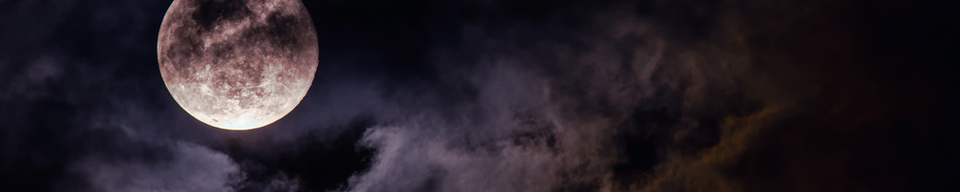 bright full moon in a cloudy night sky