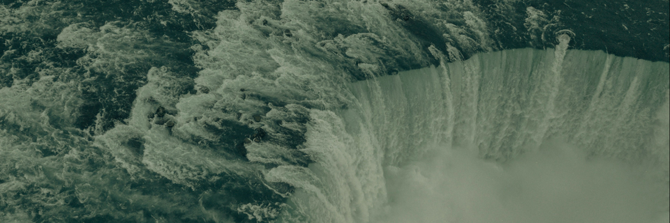 photograph of dam filled with rapidly moving water