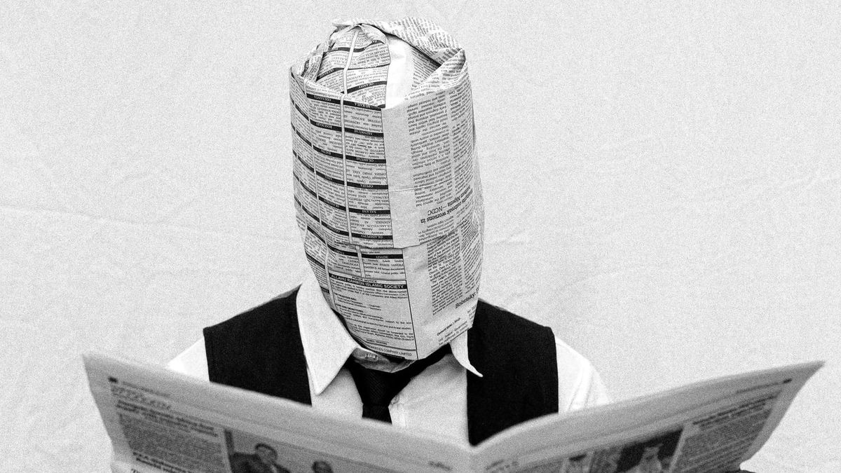 Man Reading Newspaper with Covered Face