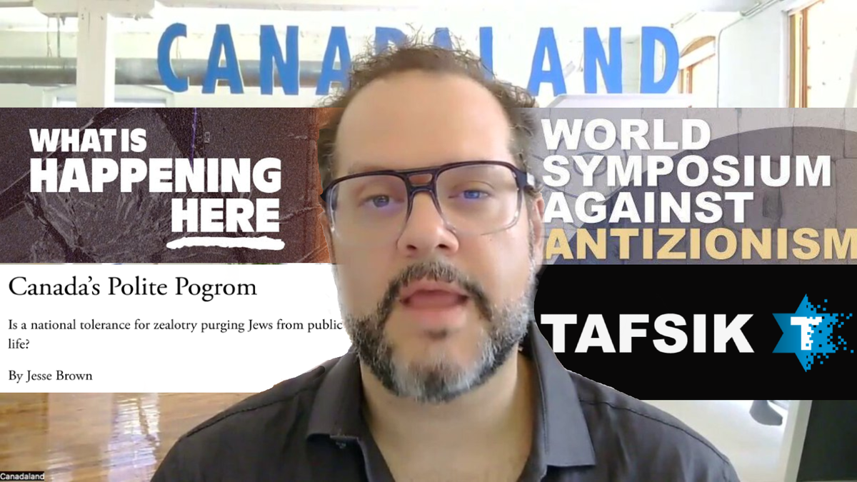 Jesse Brown in a screencap of his video defending attening the World Symposium Against Antizionism is surrounded by works he has participated in