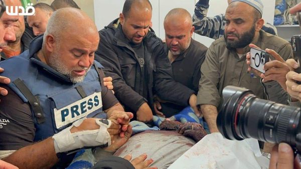Hamza al-Dahdouh's body surrounded by mourners as his dad, Wael, holds his hand and saays goodbye, clad in press body armour.