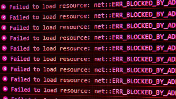 A computer screen showing the error "X Failed to load resource: net :: ERR_BLOCKED_BY_AD" repeatedly