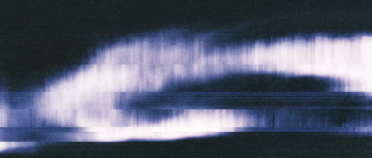 blurred, glitchy streak of pale violet light against a dark navy background, smeared horizontally like a distorted video still