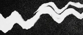Grainy black and white photograph of a waving line of light
