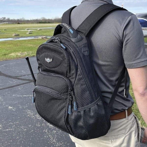 Image of a student pilot carrying a backpack