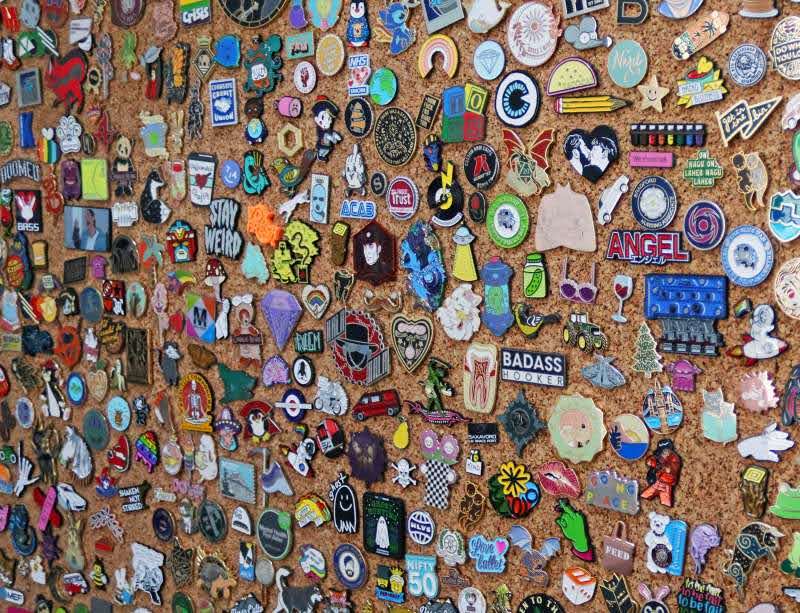 Ceramic pins displayed on a cork board