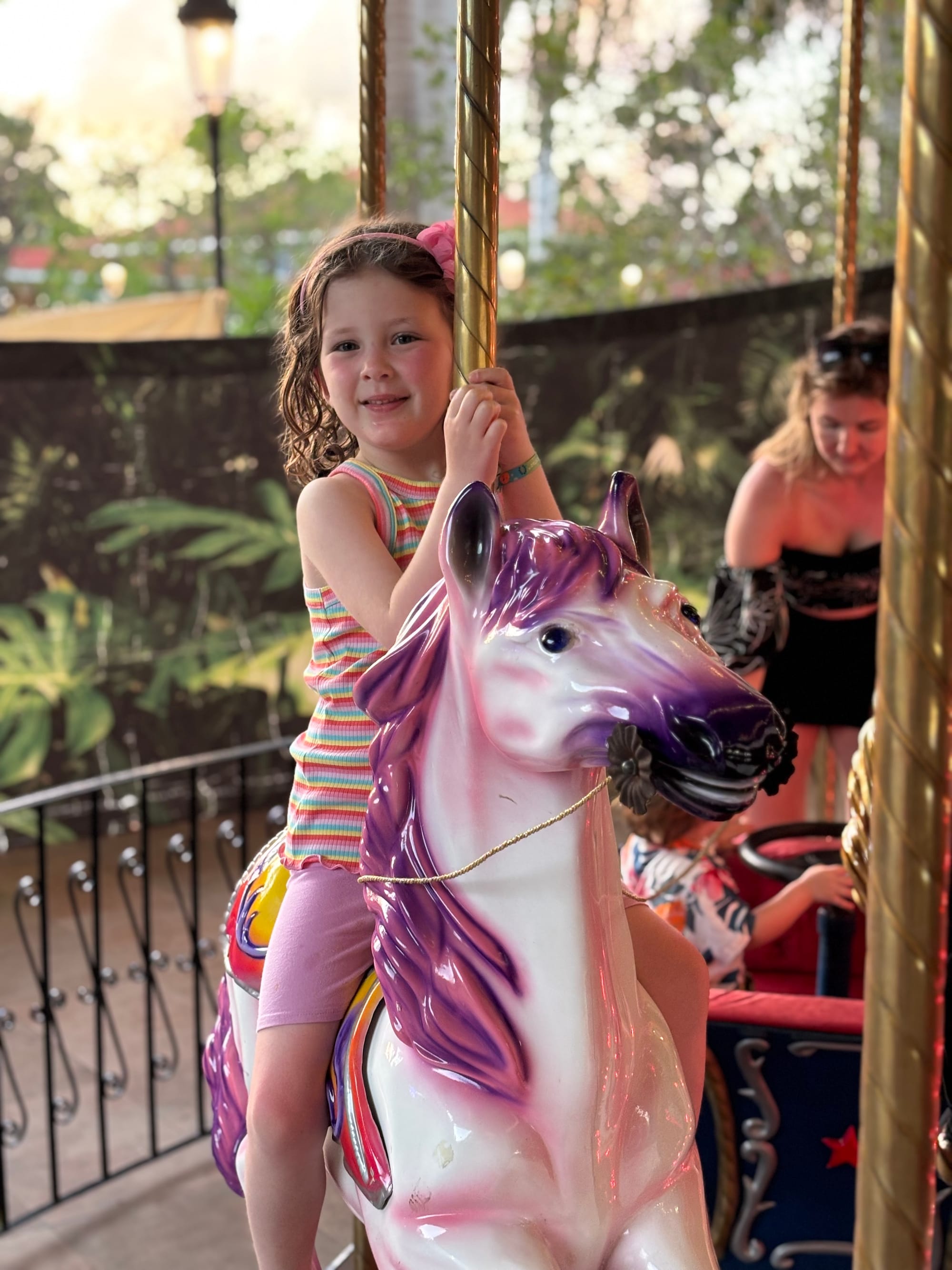Little girl riding a carousel