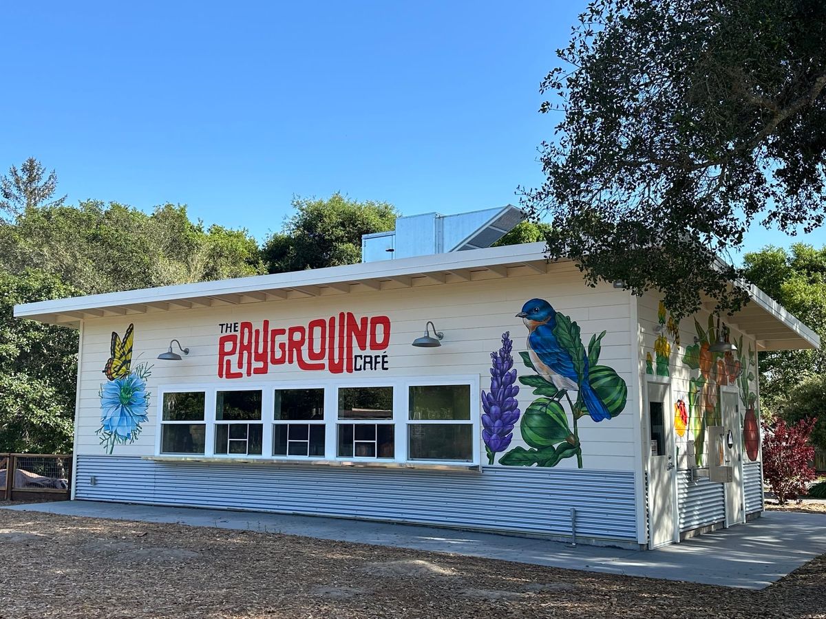 Photo of a cafe building with flowers, birds, and butterfly paintings on the facade
