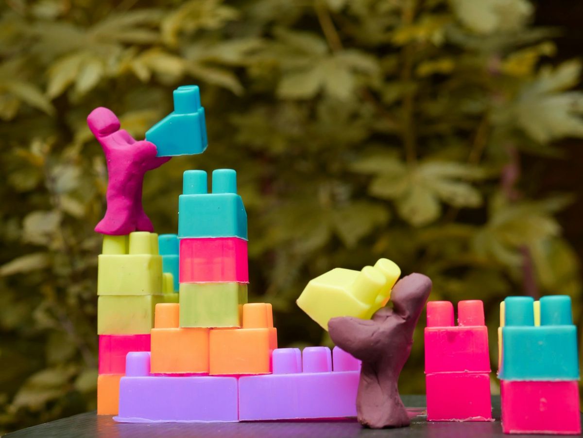 Clay figures stacking tiny toy blocks
