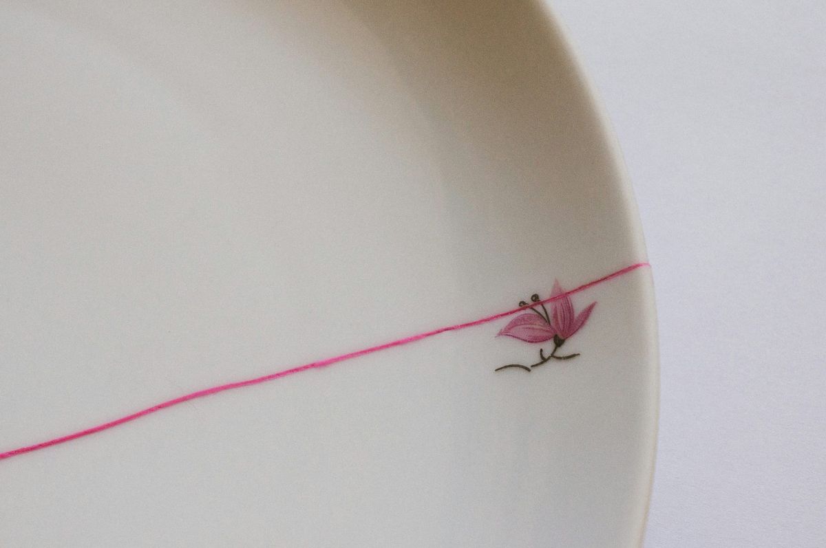 A cracked dish with a flower on it