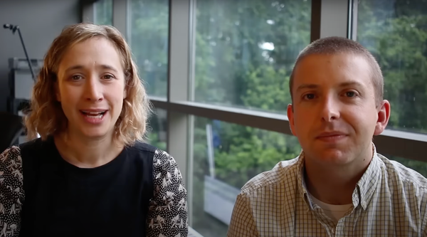 Sarah Lefton and Kyle Oliver in front of window