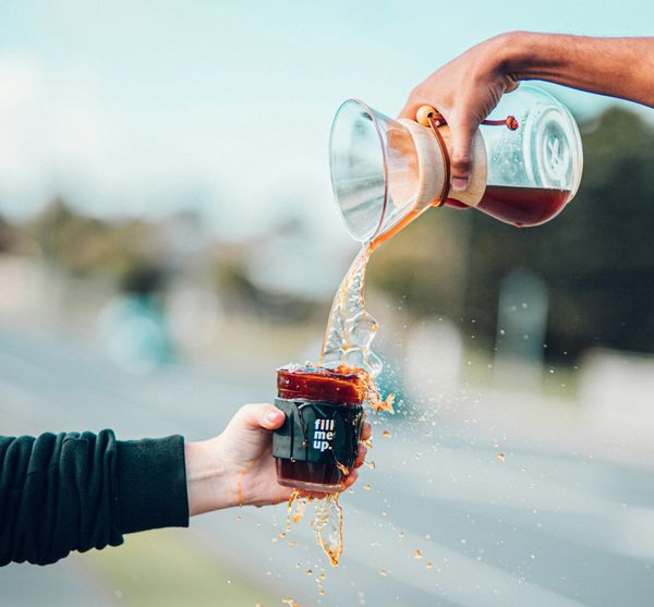 Coffee cup being filled to overflowing