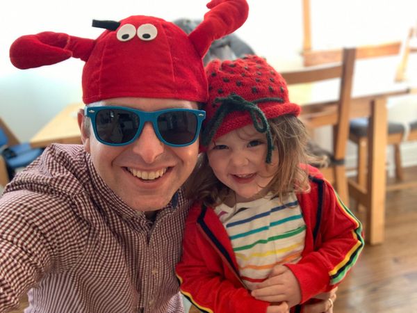 Kyle and Fiona pose in silly hats