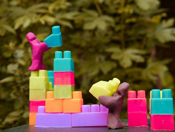 Clay figures stacking tiny toy blocks