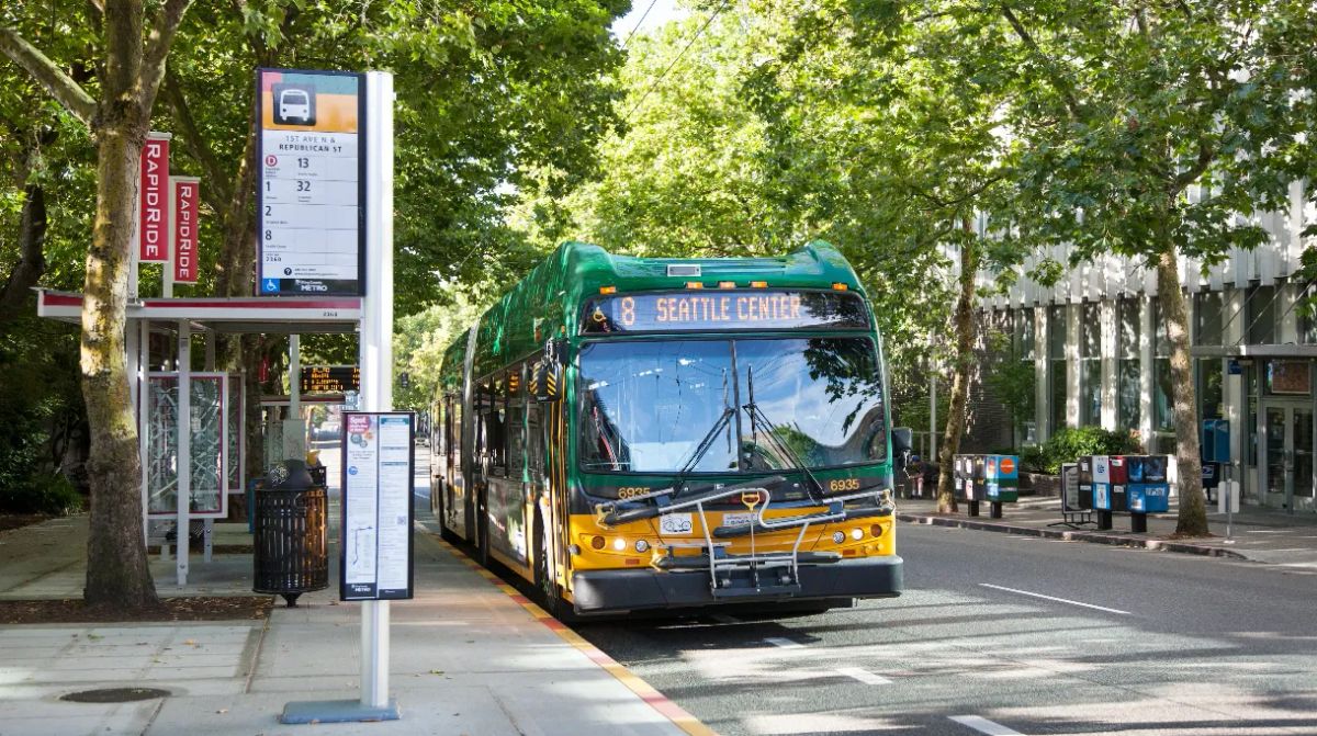 A bus with the number 8 headed to Seattle stops at an urban bus stop
