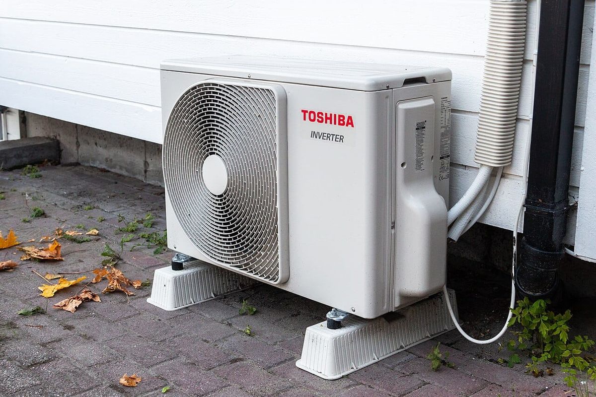 A heatpump compressor outside a home.