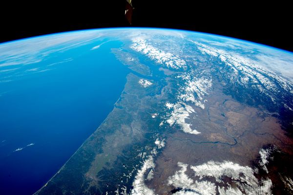 A view of the Earth from space, with the Pacific Ocean and the mountains and deserts of Cascadia, including Oregon, Washington, and British Columbia visible.