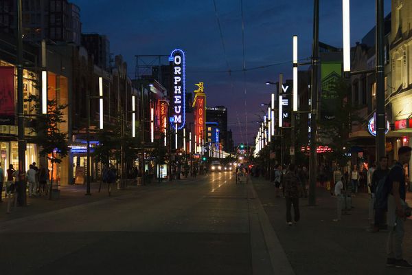 A view at night of Granville street in Vancouver with neon signs from the Orpheum theater and other businesses prominent