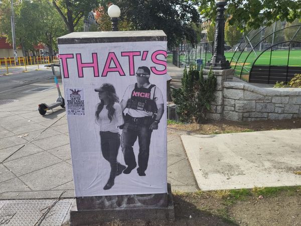 Street art at the entrance to a park showing an image of an officer with NICE emblazoned on his chest arresting Homeland Security secretary Kristi Noem.