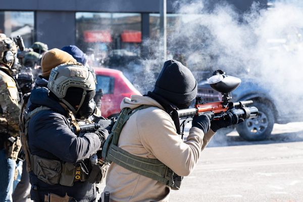 Goons in helmets and face masks fire tear gas canisters from rifles