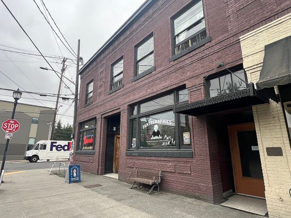 A storefront in a gritty brick building .