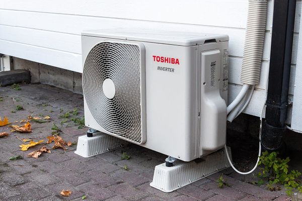 A heatpump compressor outside a home.