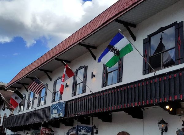 A hotel displays flags from Mexico, the US, Canada, and Cascadia.