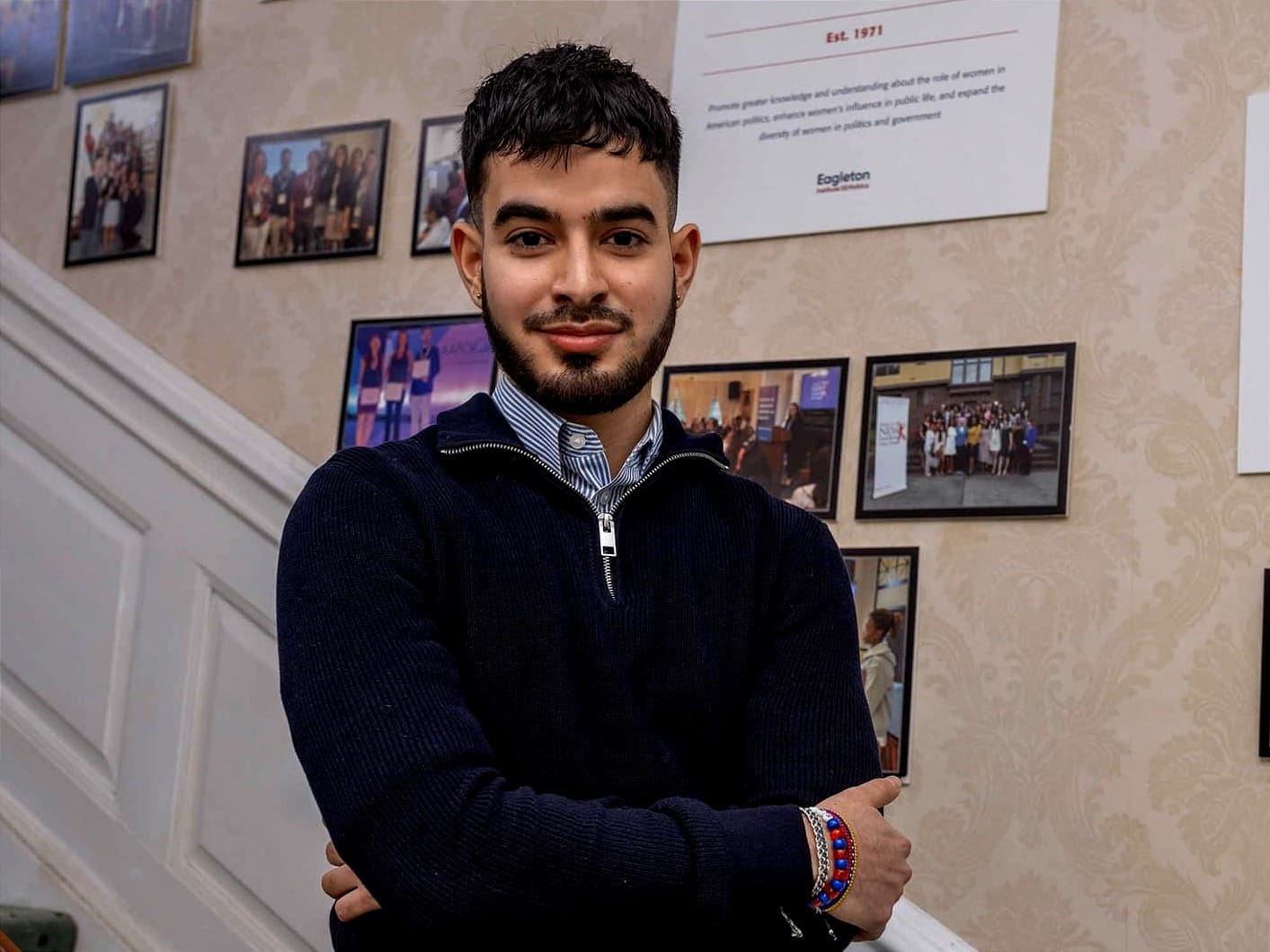 Rafael Escalante stands on the stairs within Wood Lawn Mansion, home of the Eagleton Institute of Politics at Rutgers-New Brunswick.