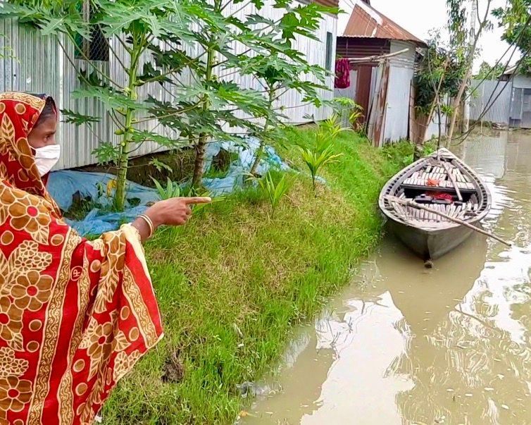 A woman points to flooded areas of Bangladesh's Gaibandha district in August 2020