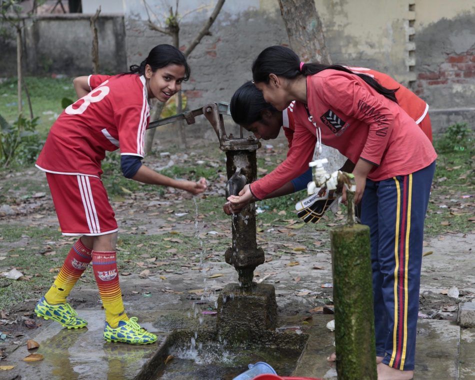 Members of a girls' football team in Bangladesh that requires them to stay in school