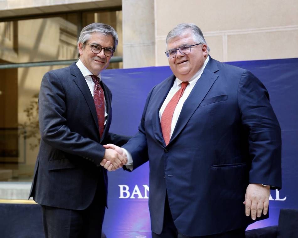 Agustín Carstens, general manager of BIS, shakes hands with Mario Marcel Cullell, then-governor of Chile's Central Bank