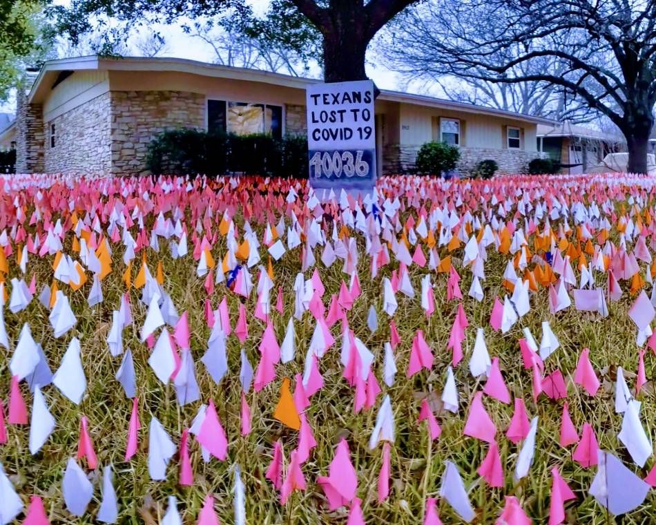 Flags for coronavirus victims planted in a lawn in Austin, Texas in 2021