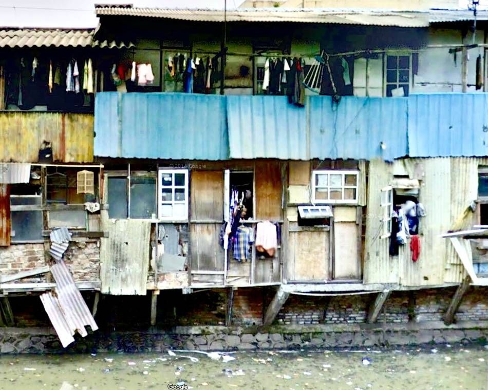 Street scene of extreme poverty, lack of clean water and waste management in Jakarta, Indonesia