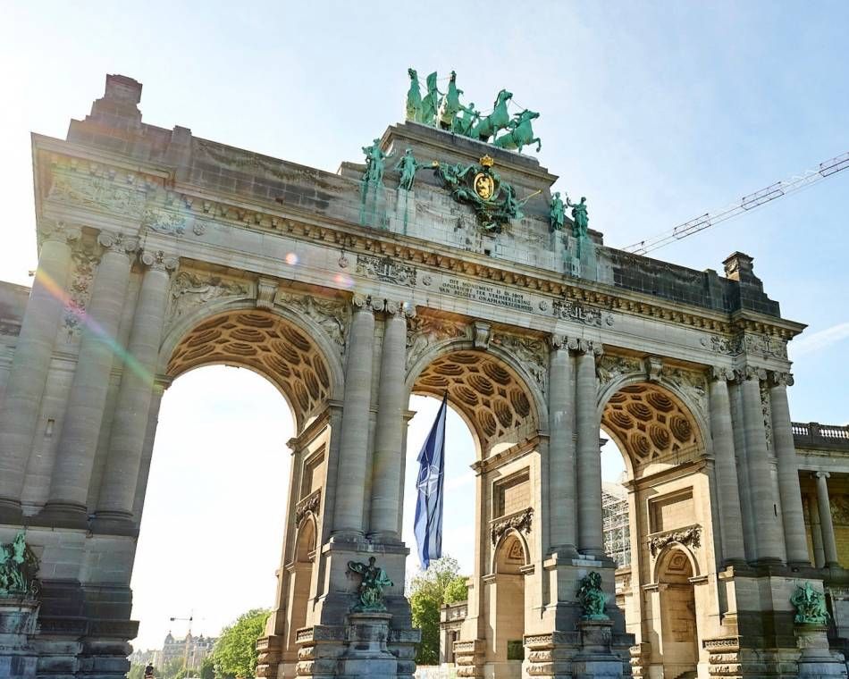 A NATO flag flies under the Cinquantenaire Arch in Brussels to mark the summit