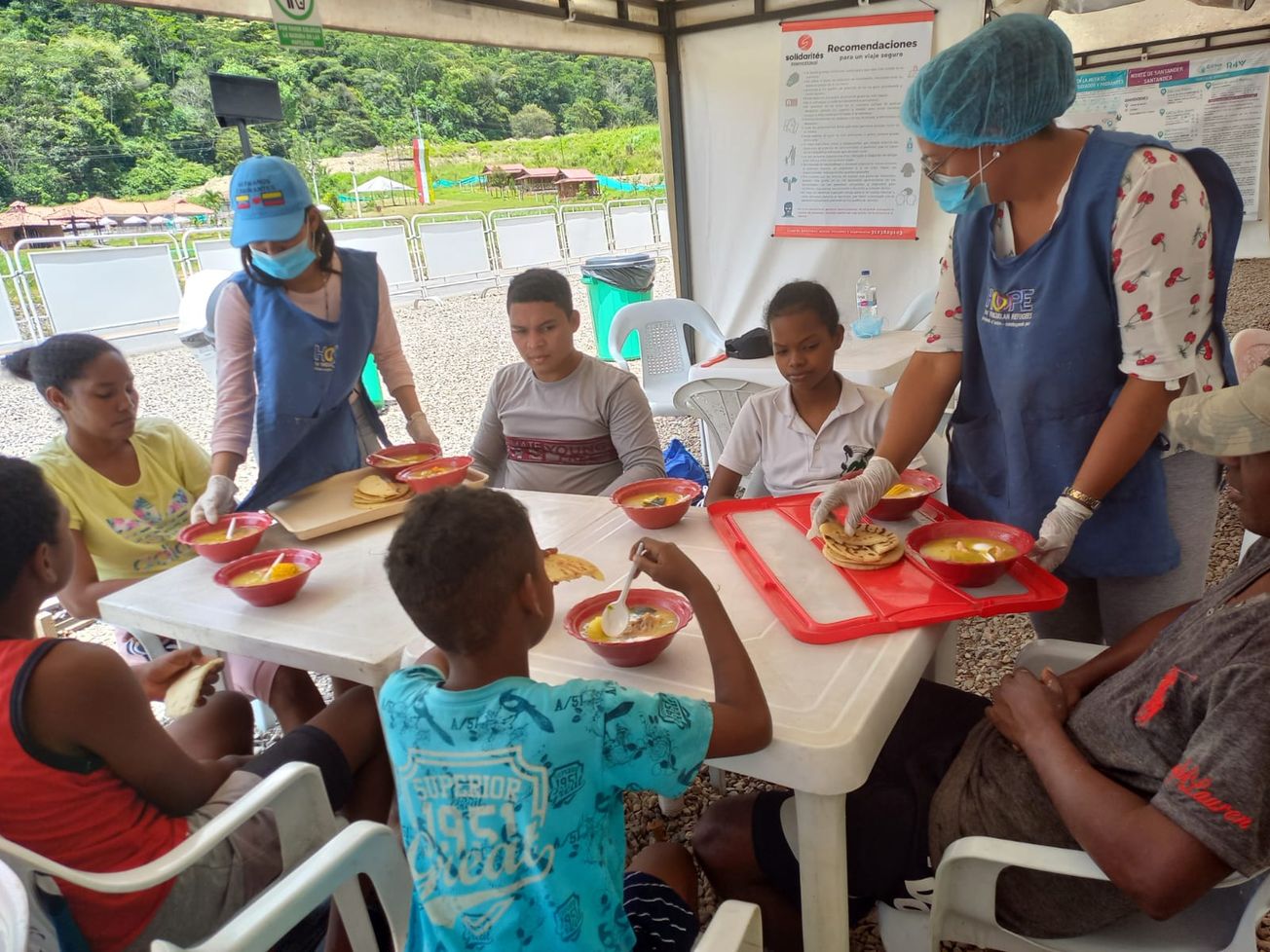 Venezuelan refugees eating soup as part of an international aid program in Colombia
