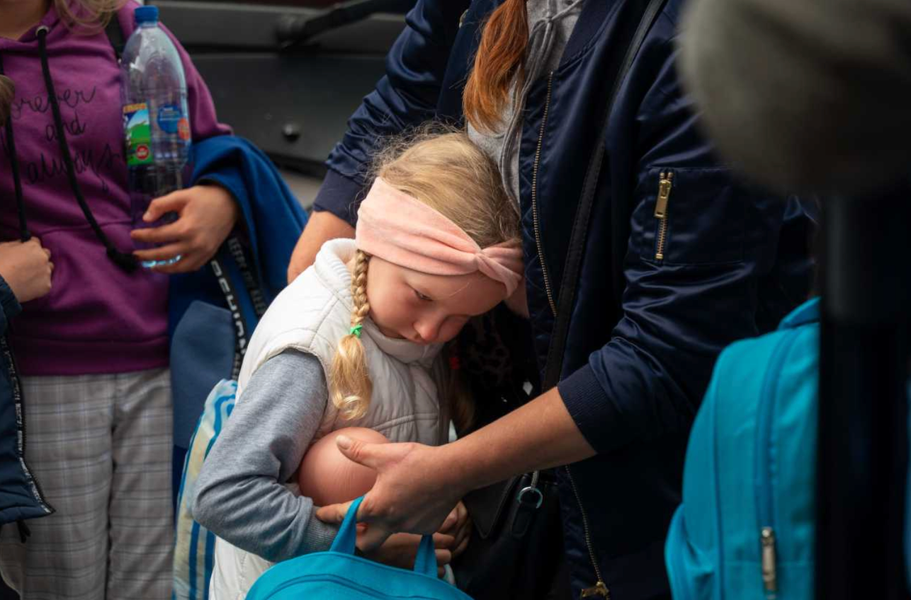 A child and her mother fleeing Ukraine for Poland in September