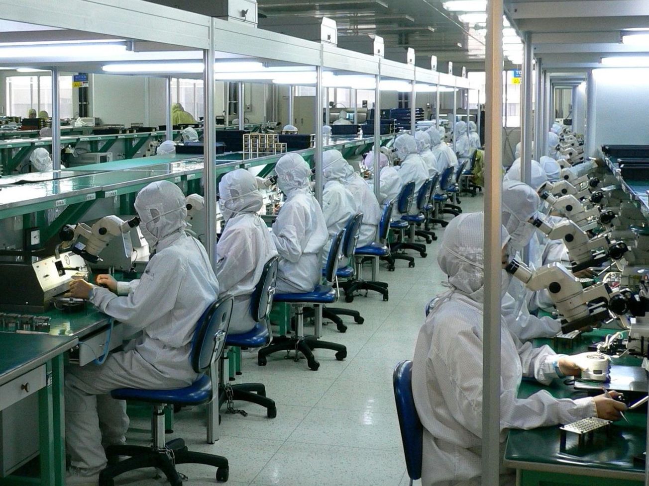 Chinese factory workers assembling and testing fiber optic systems