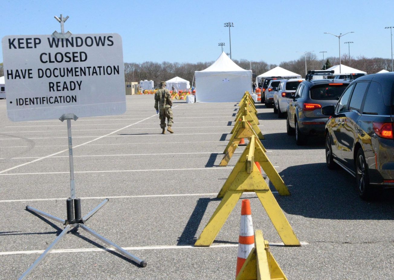 U.S. soldiers check motorists at a drive-thru coronavirus testing site in New York on March 18, 2020