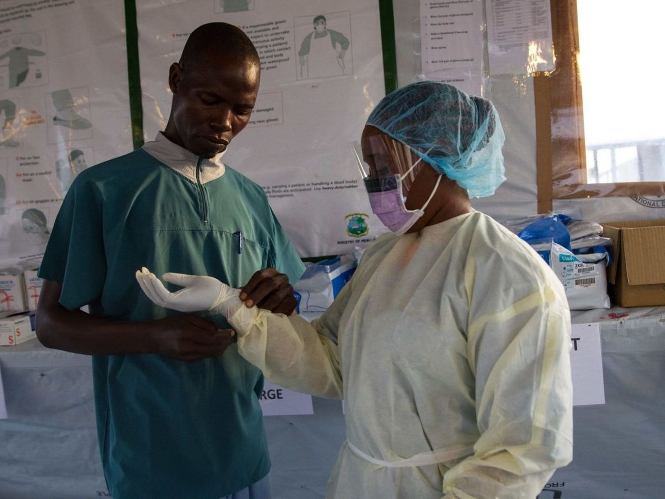 Ebola survivor and nurse Siah Tamba suits up at an Ebola treatment clinic