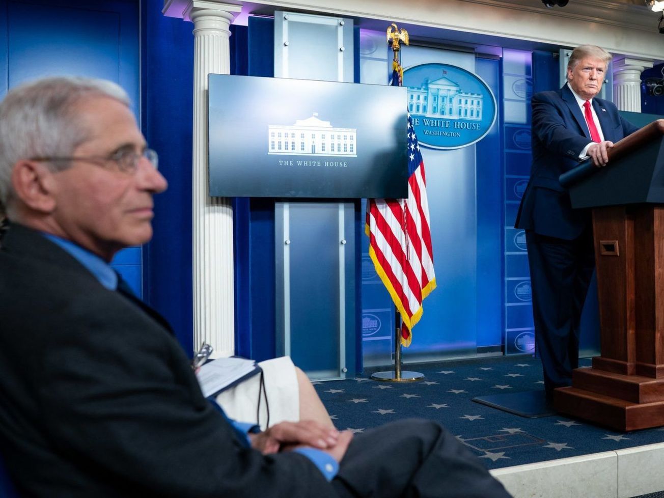 Dr. Anthony Fauci listens as U.S. President Donald Trump speaks at the White House