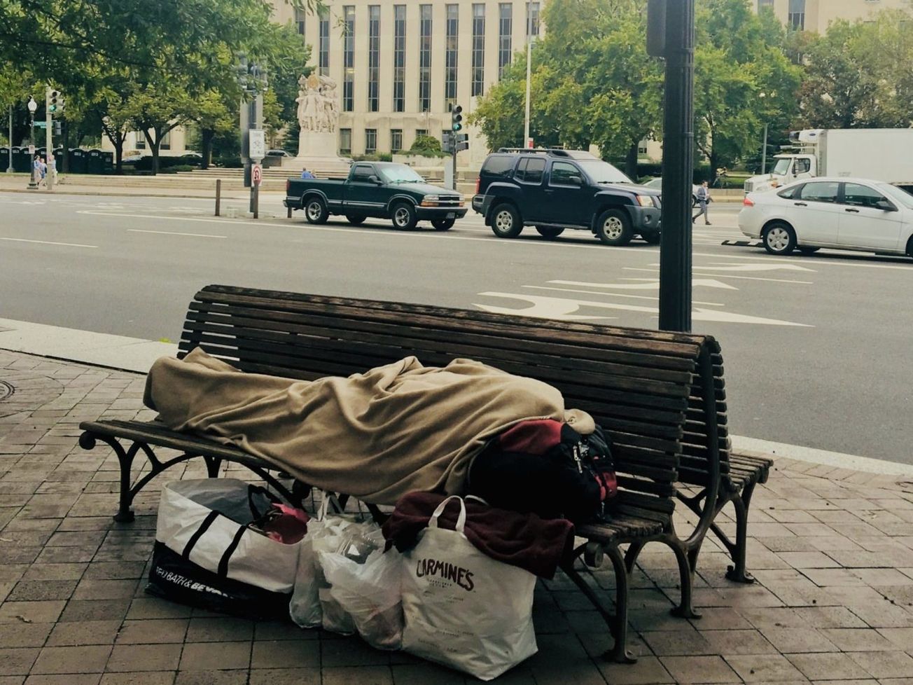 A homeless person across from a federal courthouse on Constitution Avenue in downtown Washington