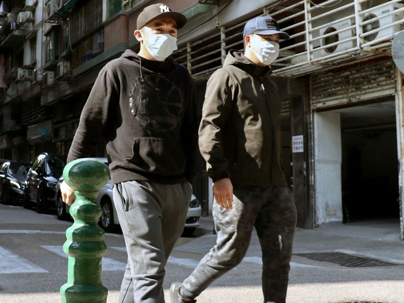 Two men in Macao wearing face masks against the coronavirus